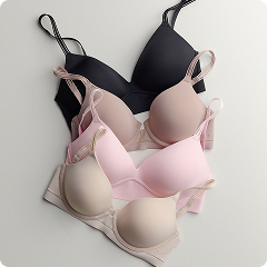 a pile of different colored bras