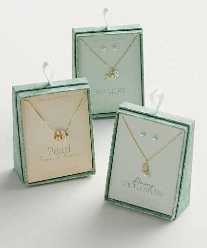 3 green gift boxes each displaying a different necklace.