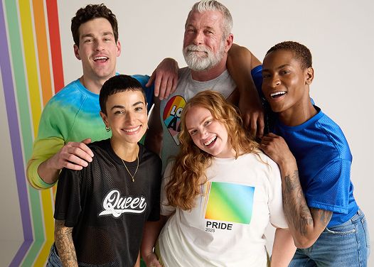 Diverse group of friends embracing and smiling for the camera.