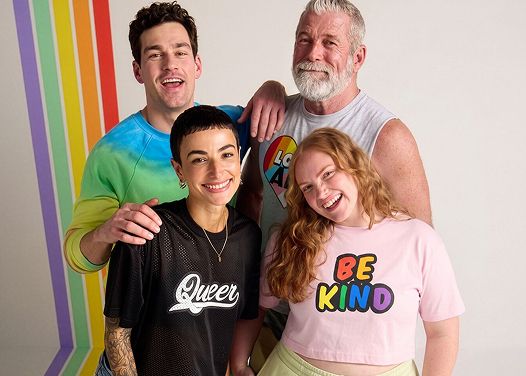 Diverse group of friends embracing and smiling for the camera.