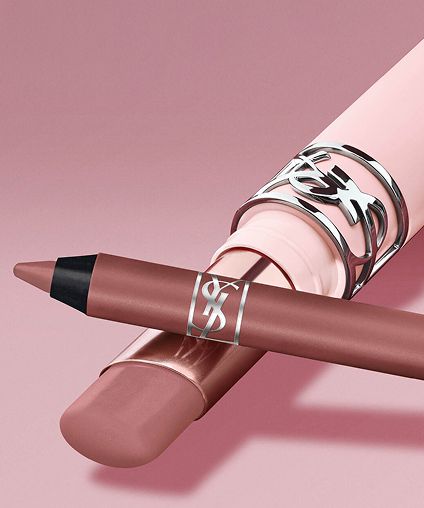YSL Lip gloss and liner product crossed over a pink background.