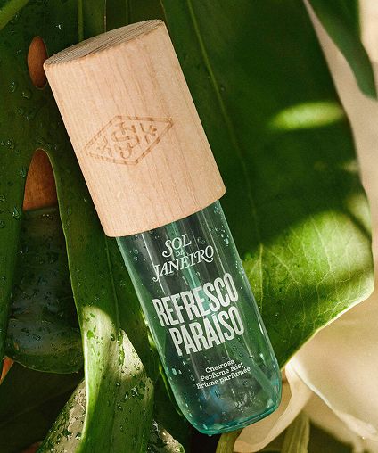 Sol De Janeiro Refresco Paraiso body mist bottle on leaves.