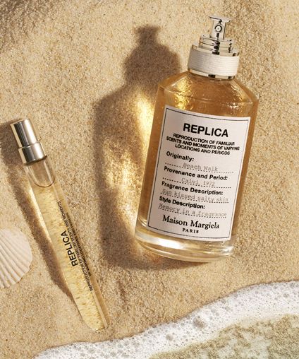 Fragrance bottle and travel spray on sand