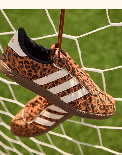 Leopard print Adidas sneakers hanging.