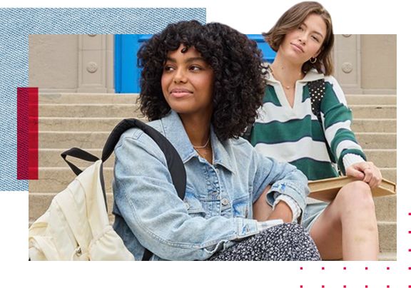 Two women sitting on steps with backpacks and books.