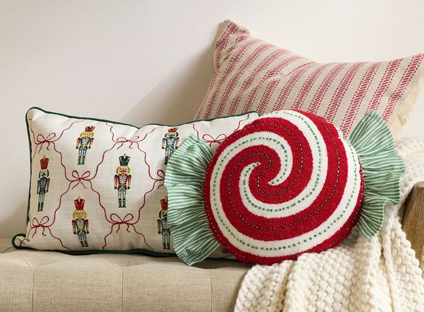 Nutcracker and peppermint-themed Christmas pillows.