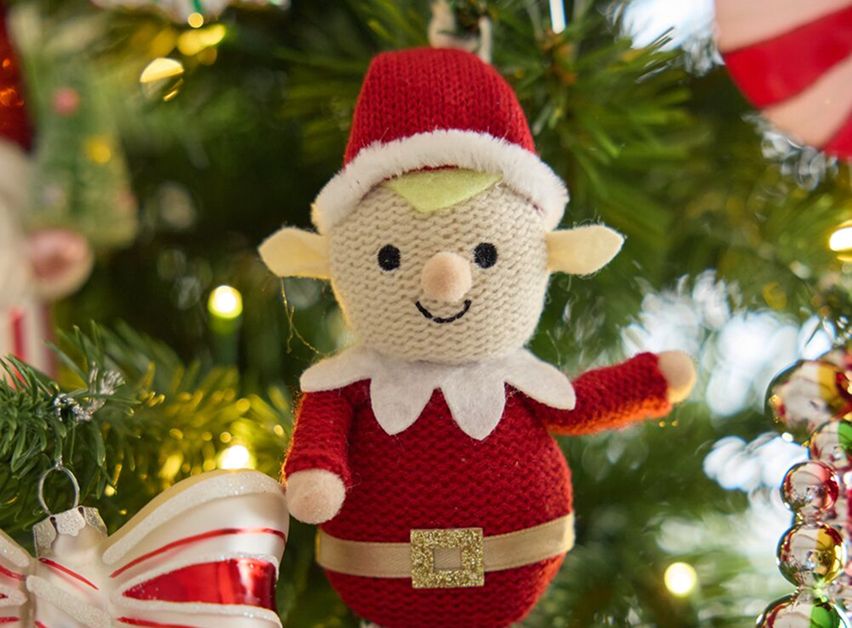 Knit elf ornament on a Christmas tree.