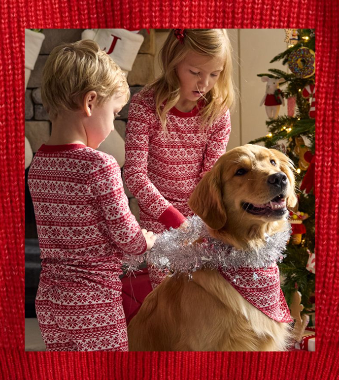 children playing with their dog in cozy pajamas