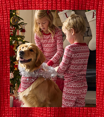 children playing with their dog in cozy pajamas