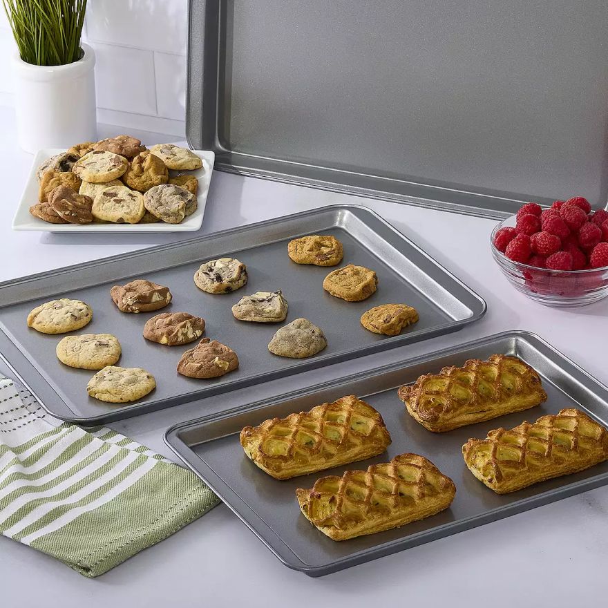 Two cookie sheets filled with baked goods