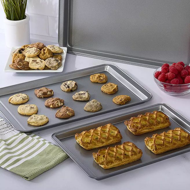 Two cookie sheets filled with baked goods