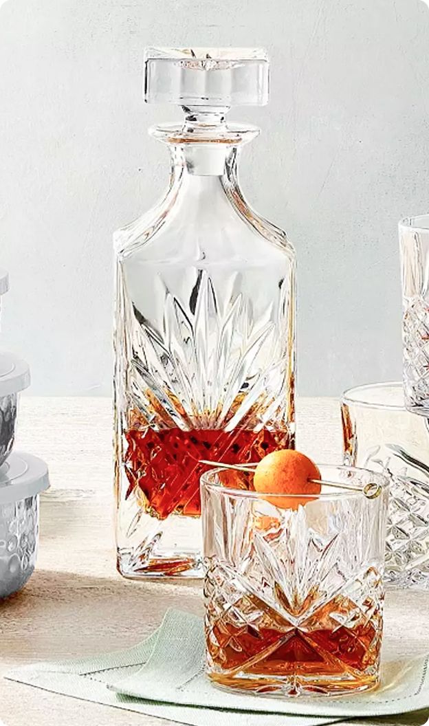 Image of Decanter behind a cocktail glass.