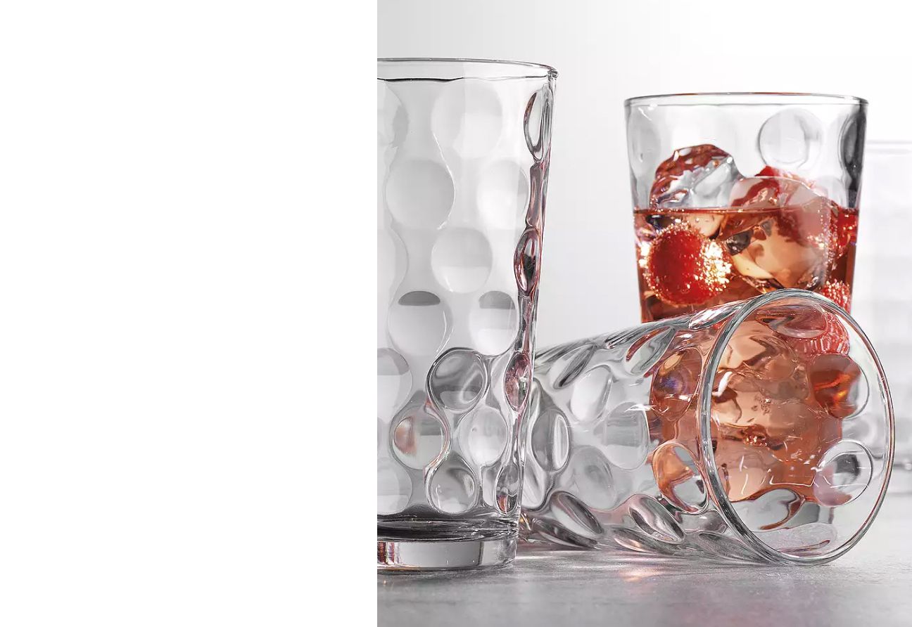 3 casual glasses, one filled with liquid