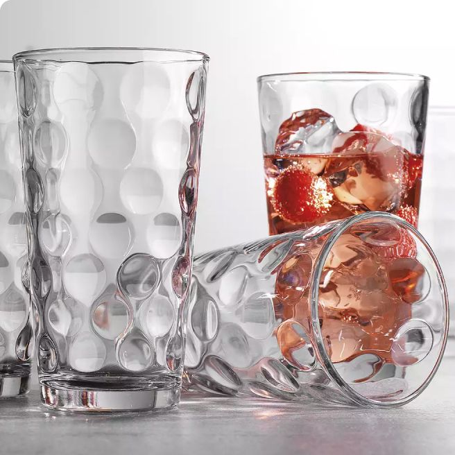 3 casual glasses, one filled with liquid