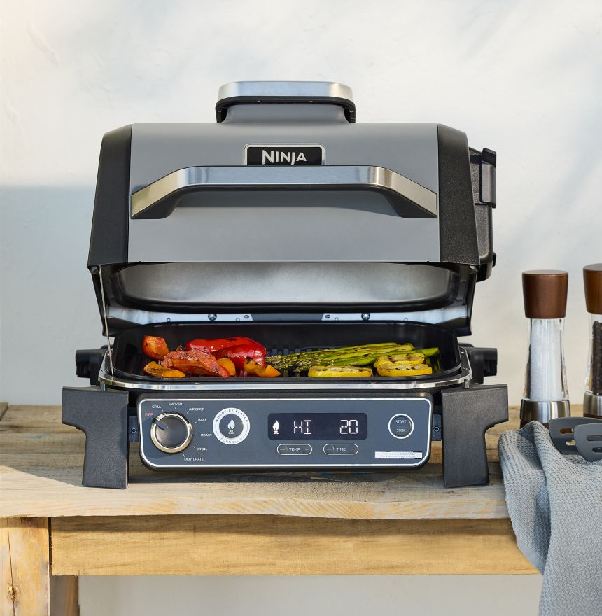 Outdoor Grill with various food items cooking