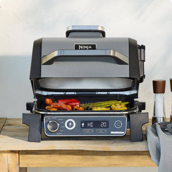 Outdoor Grill with various food items cooking