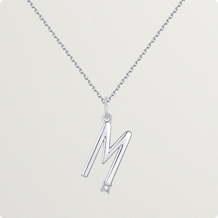 Necklace with an 'M' shaped pendant.
