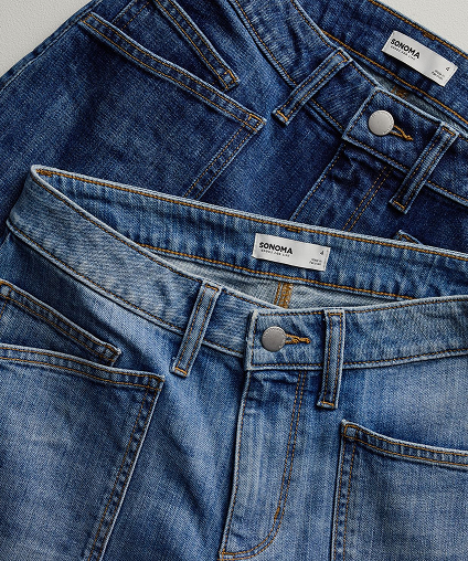 Two sets of denim jeans stack on top of eachother.