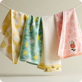 Various pastel colored hand towels hanging on a rope.