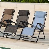 Three patio chairs of different colors positioned side by side.