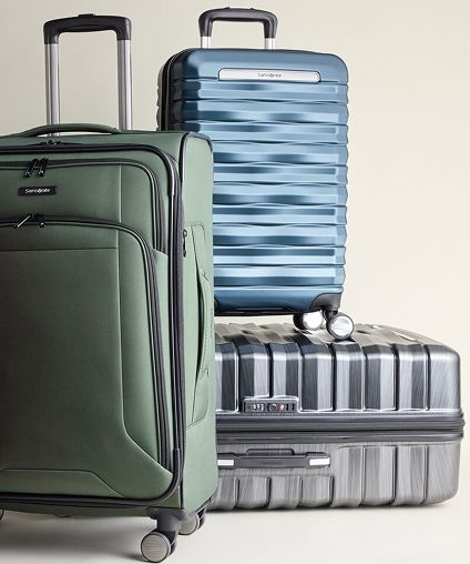 Collection of Samsonite luggage - green, blue, and gray.
