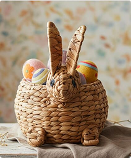 Wicker bunny-shaped basket filled with painted eggs.
