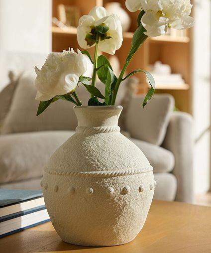 Collection of various home goods displayed over a neutral background.