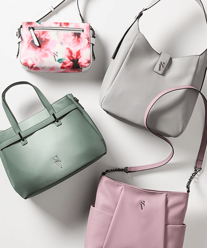 Assorted purses aligned over a gray background.