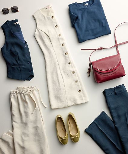 Different sets of work appropriate clothing laid out on a gray background.