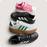 Assortment of various colored athletic shoes and sneakers over a gray background.