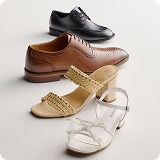 Assortment of various colored dress shoes over a gray background.