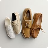 Assortment of various colored casual shoes over a gray background.