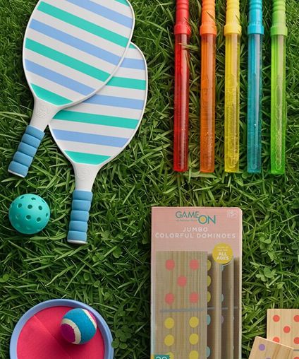 Various outdoor toys arrranged over grass.
