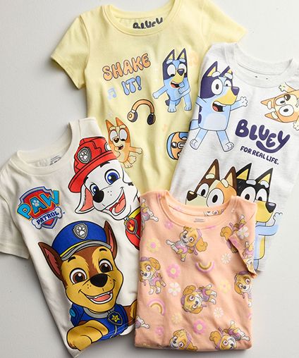 Assorted folded character tees laid on top of each other.