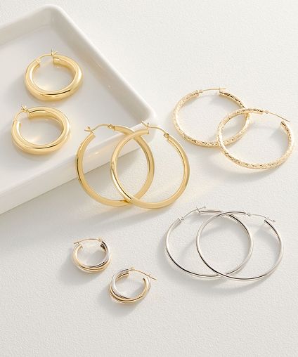 Assorted earrings over a white background.
