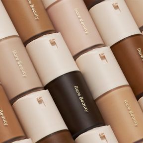 6 rows of Rare Beauty foundation containers stacked on top of eachother.