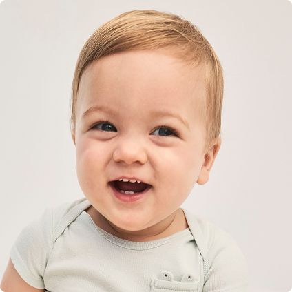 Baby boy in light grey bodysuit