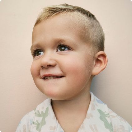 Toddler boy in patterned button-up shirt
