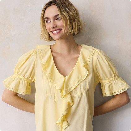 Woman in yellow ruffled v-neck top