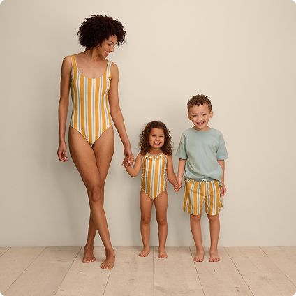 Family wearing matching striped yellow swimwear