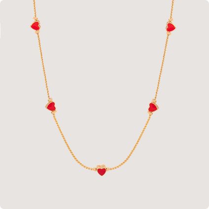 Gold necklace with red heart charms