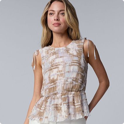 Woman wearing neutral patterned ruffle top