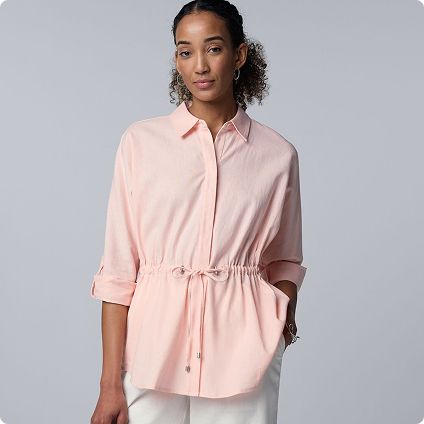 Woman wearing peach long sleeve shirt