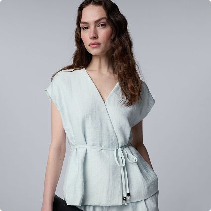 Woman wearing light blue wrap blouse