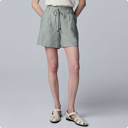 Woman wearing sage green linen shorts