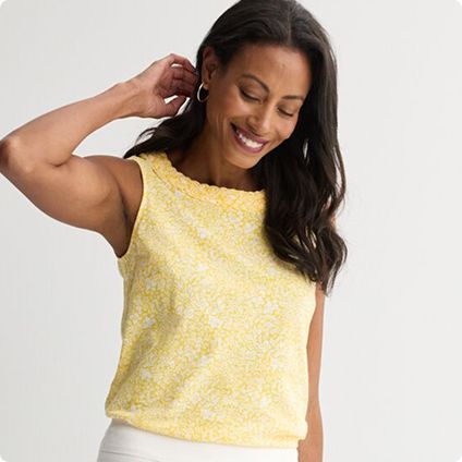 Woman in yellow sleeveless patterned top