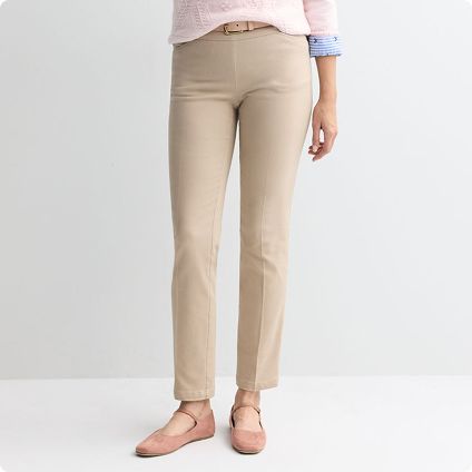 Woman wearing tan straight-leg trousers