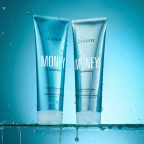 Two bottles of COLOR WOW Money Laundering Shampoo over a blue background.