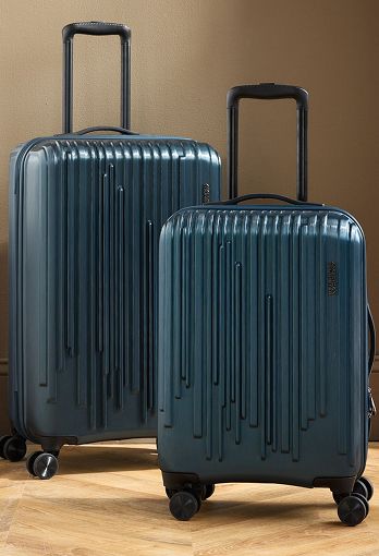 Two different-sized blue rolling luggage cases.