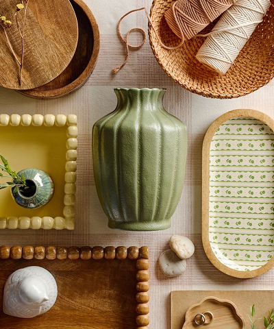 Various home goods displayed on a white and red tabelcloth.